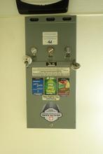 A condom dispenser at a gas station.